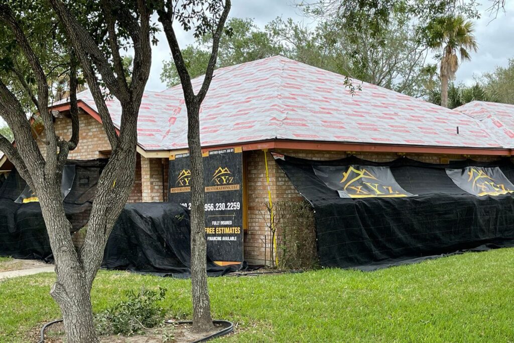 Front yard suburban home with a fixed roof from a roofing company McAllen|Black truck parked outside a building with metal roofing in McAllen.