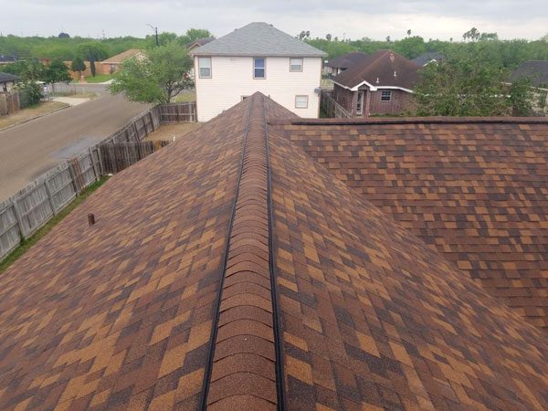 Brown shingles on a residential roof's harlingen.