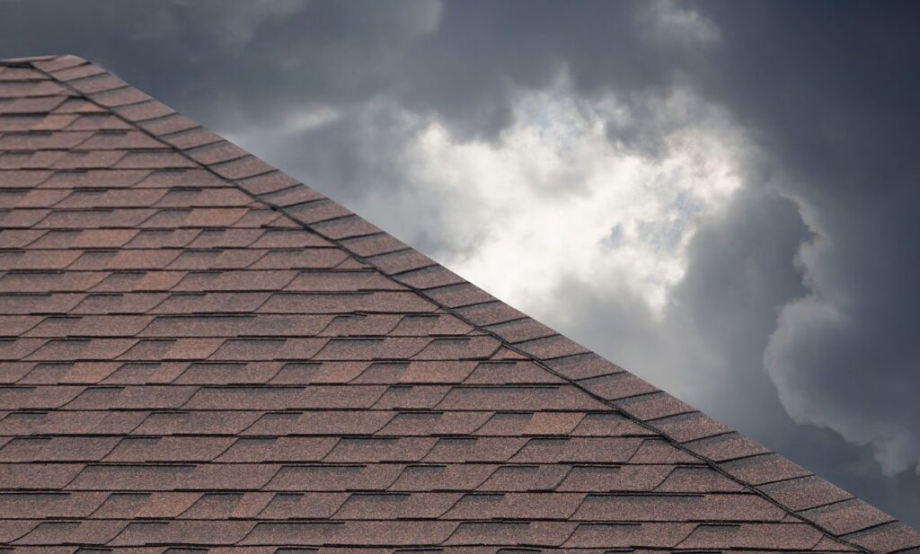 storm clouds behind a brown slates of a residential roofing company brownsville