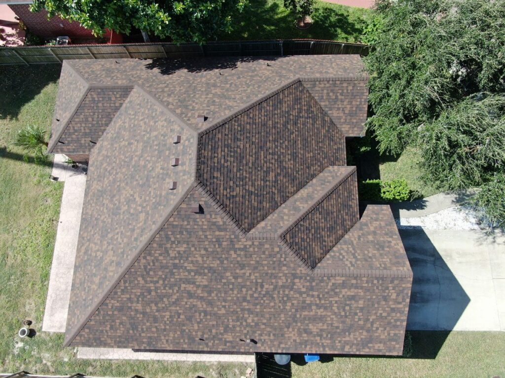 Luxury home with beige and gray shingles from a home restoration harlingen.|luxury home with gray shingles done by xyz Residential roof restoration Harlingen.|Brown shingles on a residential roof's harlingen.