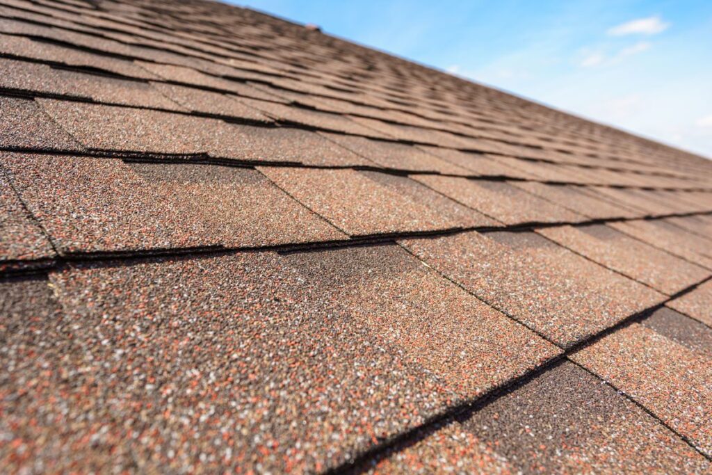 Brown-colored roofing shingles stacked by the roofing company McAllen