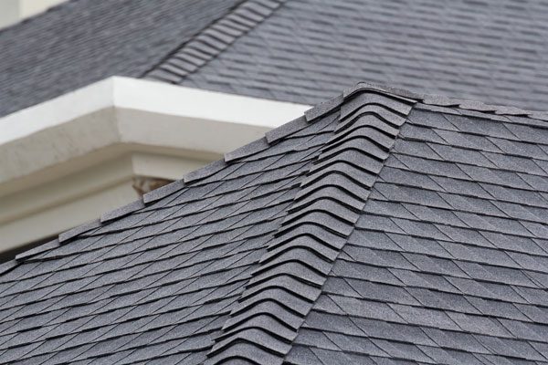 Gray-colored roofing shingles stacked by our McAllen Roofers.